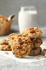 Tasty cookies with nuts on grey table, closeup