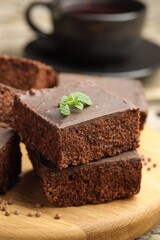 Delicious chocolate puffed rice bars and mint on table, closeup