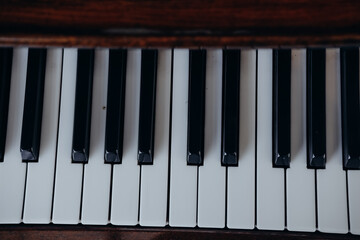 Detailed view of piano keys with a rich wooden texture during a music practice session