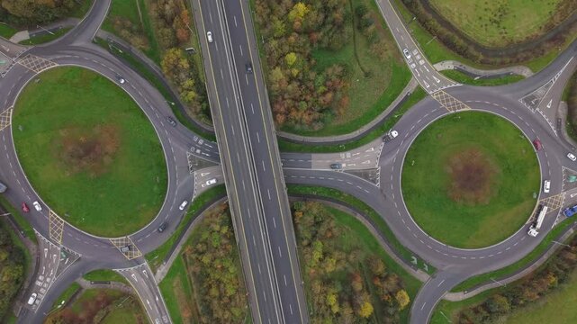 Overhead View Of Cars Driving On The Roundabouts And N18 Road In Limerick, Ireland. - aerial ascend shot