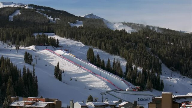 Copper Mountain Resort center village aerial drone chairlifts gondola Ikon Pass Alterra snowboarding snow ski riding trails morning winter solstice December halfpipe snow guns trees circle right