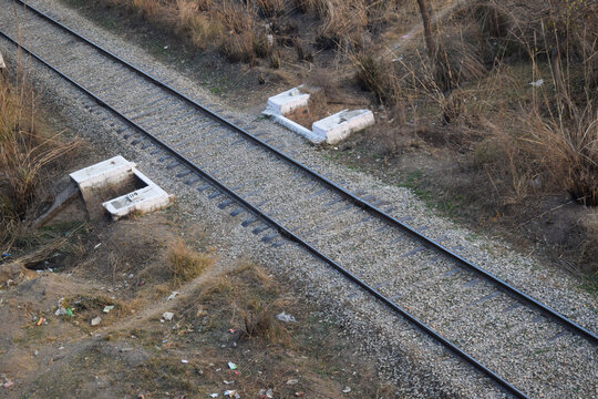 Here A single-track railway line captured symmetrically, offering a calm, ordered perspective into the horizon. This minimalist scene emphasizes clarity, direction, Pair of empty train tracks