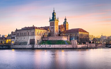 Fototapeta premium Krakow's Wawel Castle, Poland Majestic castle at sunset, reflected in calm river water.