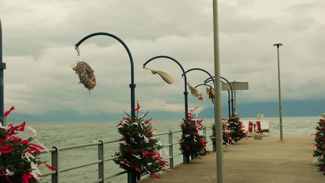 Establishing shot of Morges wharf with lake Geneva and christmas trees in Canton of Vaud Switzerland