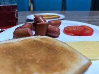 delicious breakfast of baked sausages and vegetables on a white plate.