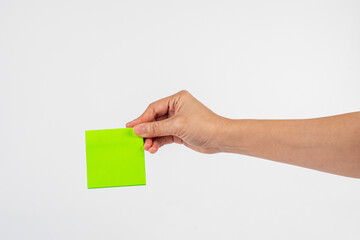 Obraz premium Paper stickers in hand. Hand holding a green sticker. Notes for the message.