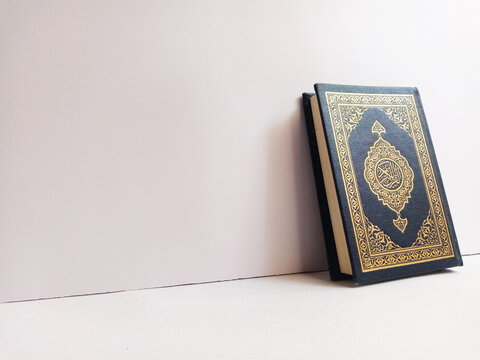 Mushaf of the Koran, Al-Qur'an, the holy book of Muslims leaning on a white background.