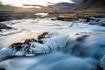 Panoramic view of flowing rushing water on the river in Kirkjubæjarklaustur or Kirkjubaejarklaustur, Iceland