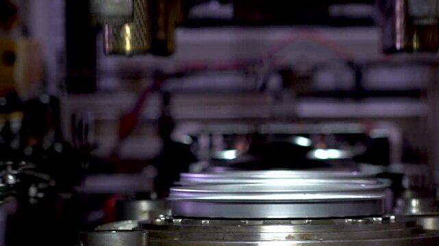 Close up view of a large hydraulic transfer press line shaping metal parts in a factory.