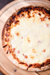 Pizza margherita on wooden background. Soft focus. Top view. Close up.
