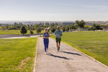 Fototapeta premium Athletes running in city park during marathon race