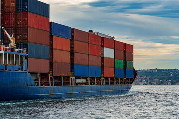 a large container ship sails along the Bosphorus, against the background of Istanbul, Turkey, a view from a pleasure boat