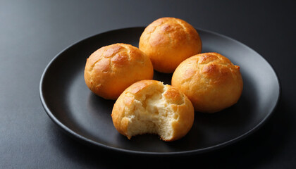 Pão de Queijo Baked Cheese Bread Rolls Close-up on Plate, Brazilian Snack