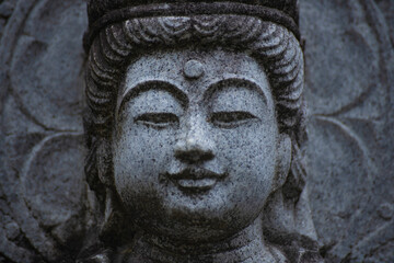 A religious stone statue of Bodhisattva Samantabhadra at Japanese buddhism temple