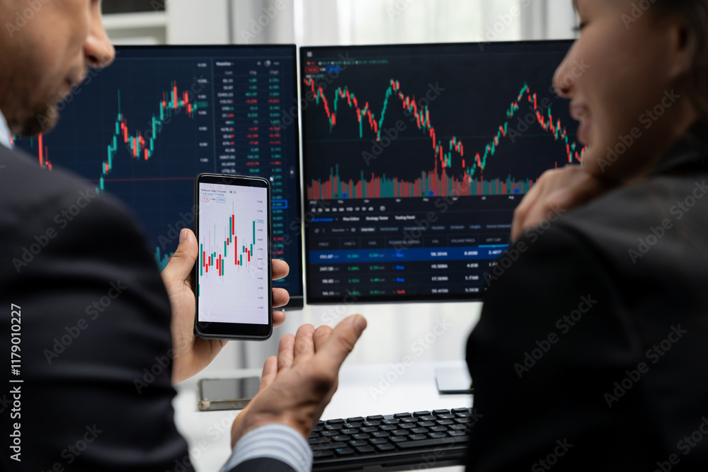 Aufkleber focusing on phone with discussing dynamic stock market in two business traders online website compar