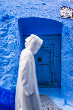Man in traditional robe at the blue city, Morocco