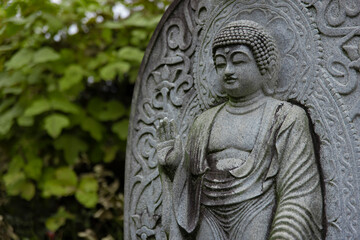 A religious stone statue of Shaka Nyorai at Japanese buddhism temple