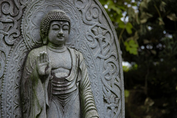A religious stone statue of Shaka Nyorai at Japanese buddhism temple