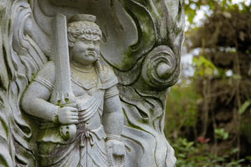 A religious stone statue of Acala at Japanese buddhism temple