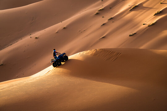 Quad on the sand dunes in the Sahara desert, Merzouga, Morocco
