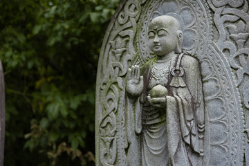 A religious stone statue of Jizo at Japanese buddhism temple