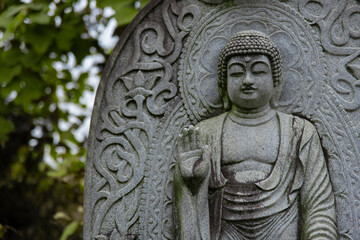 Obraz premium A religious stone statue of Shaka Nyorai at Japanese buddhism temple