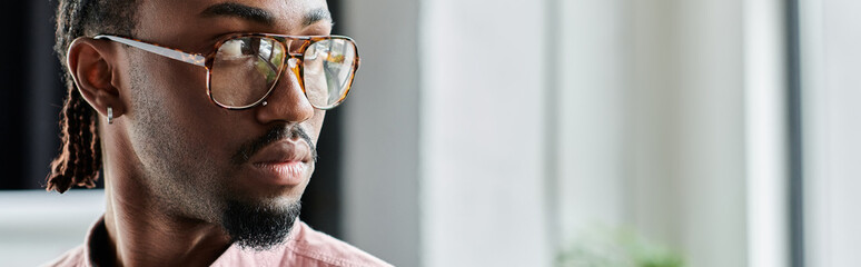 Young man focused on work in a vibrant coworking space showcasing nomadic lifestyle © LIGHTFIELD STUDIOS