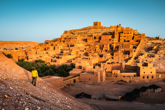 Tourist looking at Ait Benhaddou old town at sunrise, Morocco
