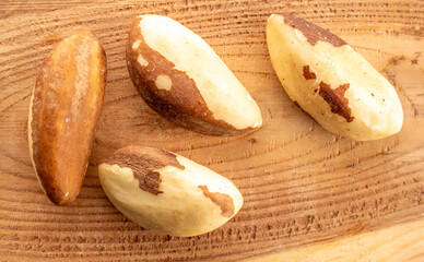 Brazil nut with homemade kitchen utensils, macro, isolated on white background and top view.