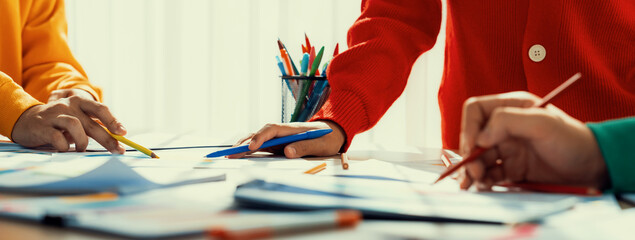 Startup company employee working together, analyzing BI dashboard paper on financial data report and planning strategic marketing for business success in panorama banner. Synergic