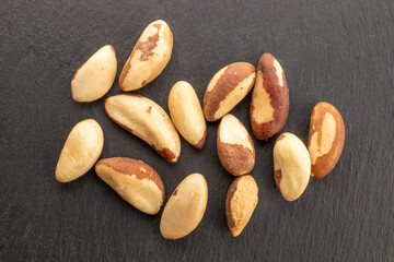 Brazil nut with homemade kitchen utensils, macro, isolated on white background and top view.