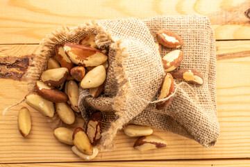 Brazil nut with homemade kitchen utensils, macro, isolated on white background and top view.