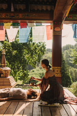 Close up of female mentor and student before Mindful meditation and yoga in the gazebo....