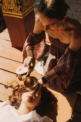 Close up of female mentor and student before Mindful meditation and yoga in the gazebo....