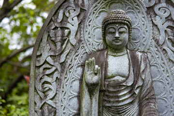 A religious stone statue of Amitabha Buddha at Japanese buddhism temple