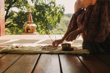 Woman practicing yoga and meditation in a Buddhist temple, relaxed with closed eyes. Mindful...