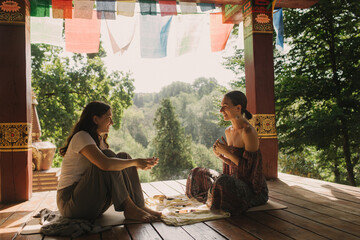 Close up of female mentor and student before Mindful meditation and yoga in the gazebo....