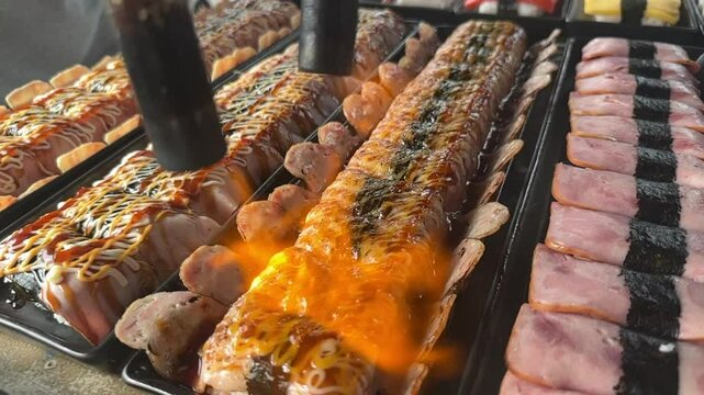 Flaming sushi and meat street food! Watch as we torch fresh sushi and meat over an open flame for an unforgettable culinary experience