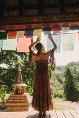 Woman practicing yoga and meditation in a Buddhist temple, relaxed with closed eyes. Mindful...