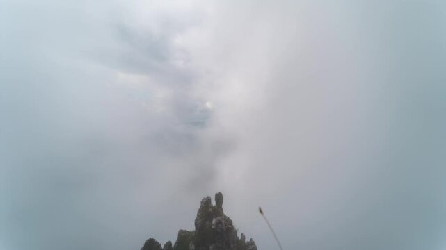 Timelapse video capturing dramatic clouds sweeping over Grignetta's rugged peaks and lush valleys