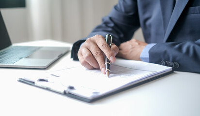 Executive CEO businessman checking job applicant documents resumes, interviews, and signing to approve the contract in the office room