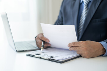 Executive CEO businessman checking job applicant documents resumes, interviews, and signing to approve the contract in the office room