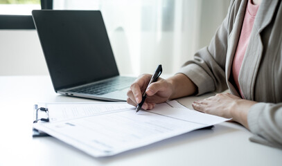 Executive CEO businesswoman checking job applicant documents resumes, interviews, and signing to approve the contract in the office room
