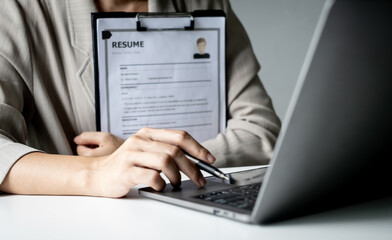 Executive CEO businesswoman checking job applicant documents resumes, interviews, and signing to approve the contract in the office room