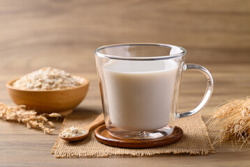 Oat milk in cup glass on wooden background, Alternative milk made from plant, non dairy