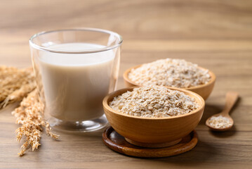 Oat milk in cup glass on wooden background, Alternative milk made from plant, non dairy