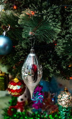 Christmas toys on an artificial Christmas tree close-up
