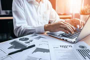 Businessman accountant or financial expert analyze business report graph and finance chart at...