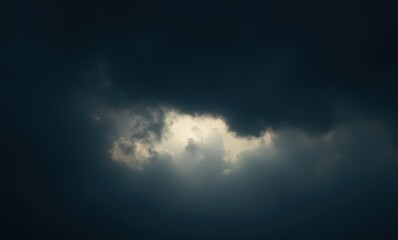 Mysterious dark clouds with sunlight peeking