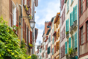 Fototapeta premium Half-timbered residential building with colored shutters in Bayonne, France